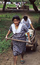 Women using simple cart to collect domestic water in Nicaragua