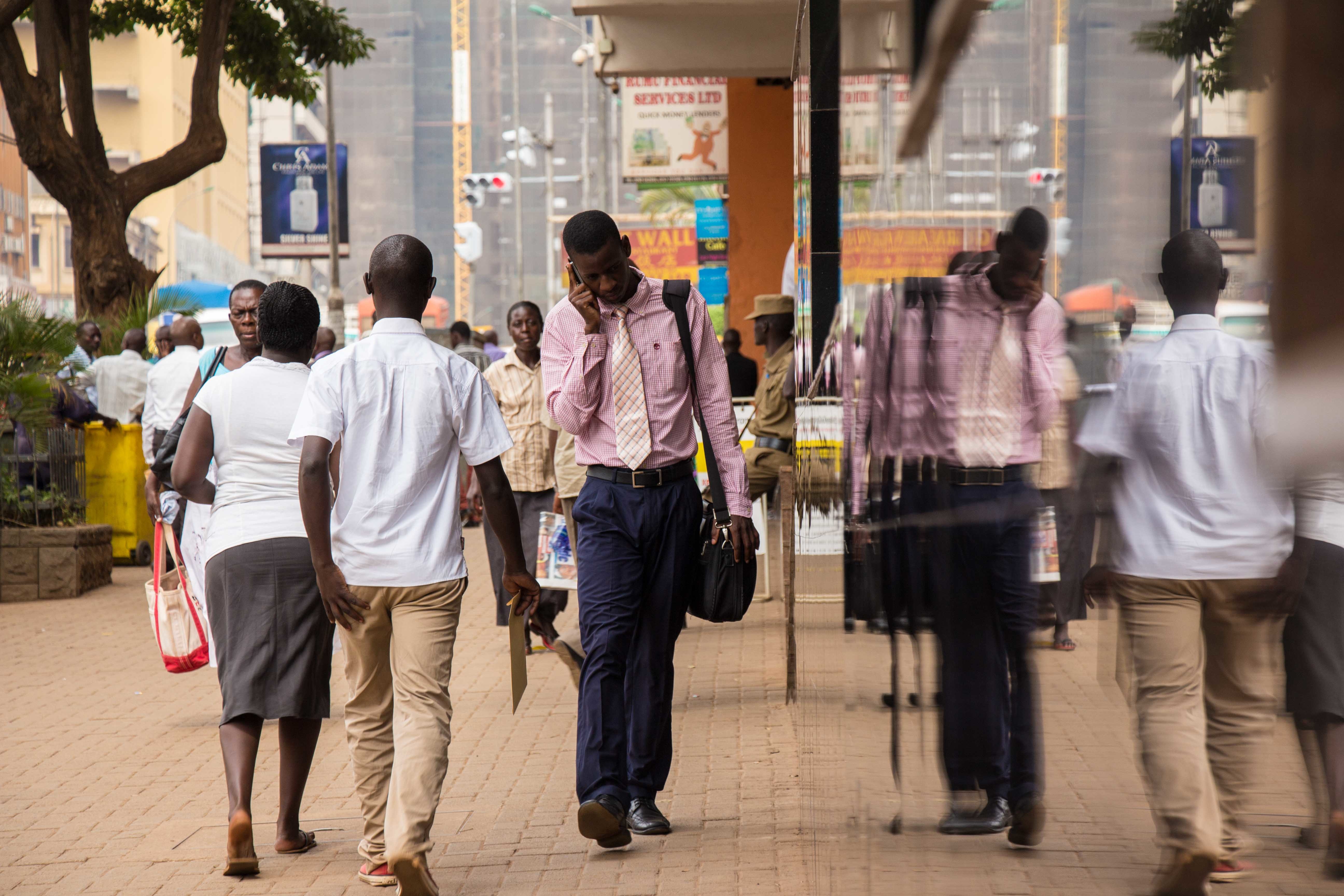 man walking in Ugandan city